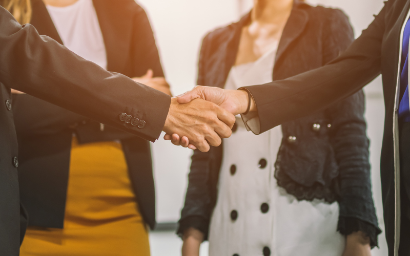 Franchise Consultants Shaking Hands Franchise consultants shaking hands in a professional setting.
